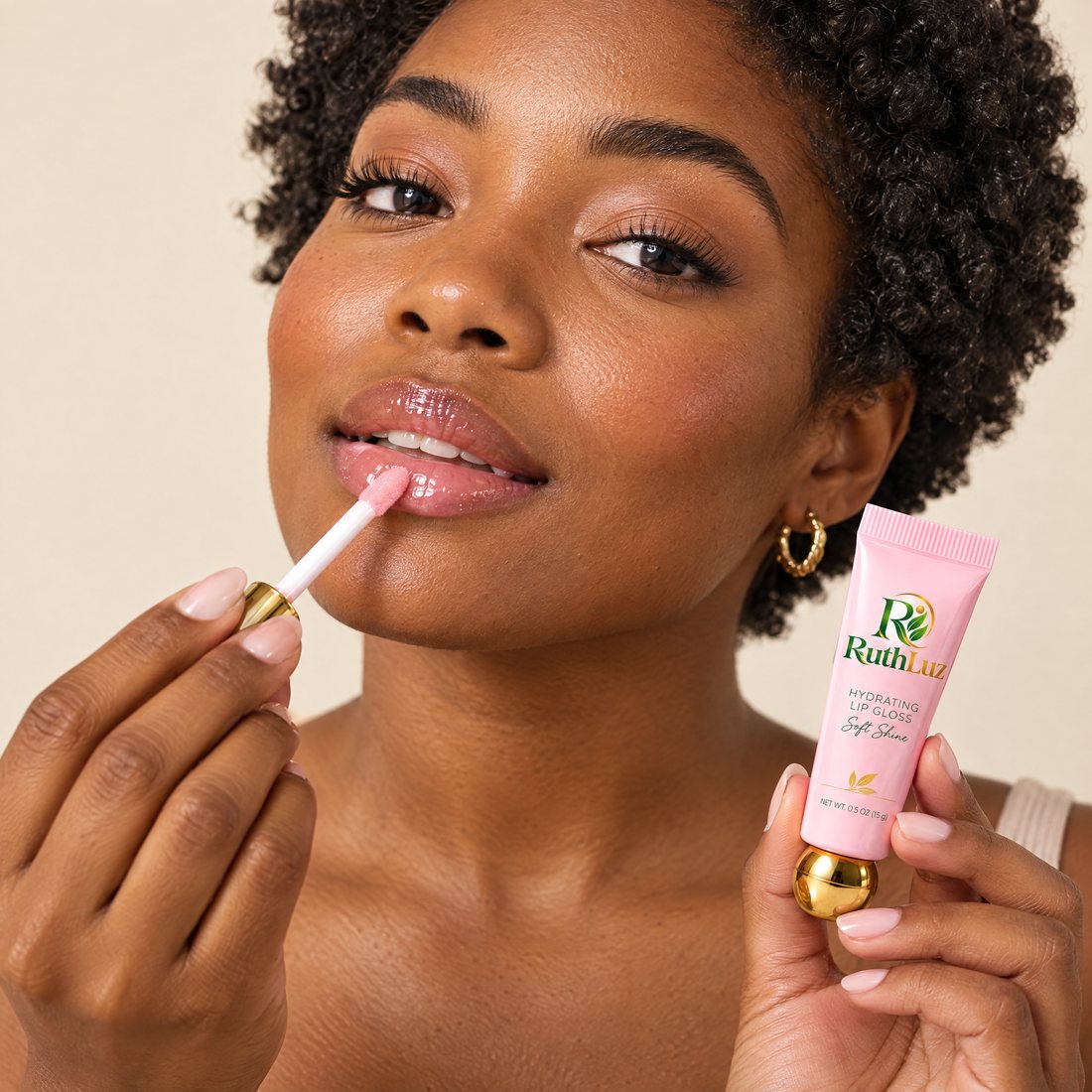 A woman applying RuthLuz Hydrating Lip Gloss with the applicator